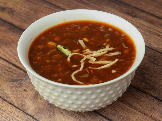 Chińskie danie z zupy Manchow serwowane na rustykalnym drewnianym tle selektywnej ostrości