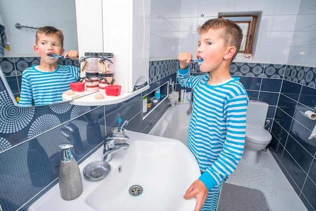 Chłopiec myje zęby w łazience