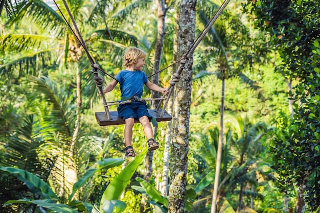 Chłopiec na huśtawce nad dżunglą, Bali.