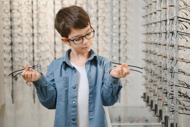 Chłopiec w okularach w sklepie optycznym