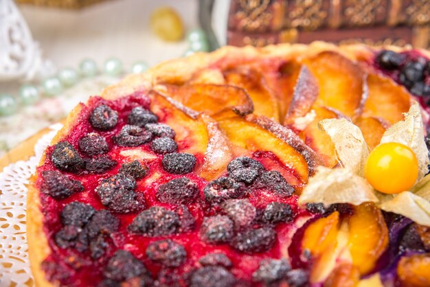 Zdjęcie ciasto jagodowe, czyli tarta wypełniona dżemem z czarnej porzeczki, w szkle tworzą szare tło. selektywna ostrość, zbliżenie.