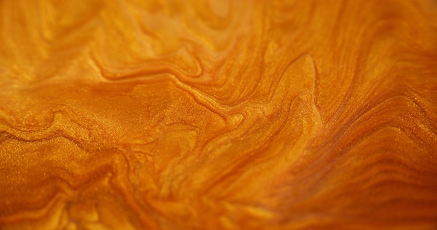 Zdjęcie ciekły błyszczący błyszcząca tekstura farby rozmyte złoty kolor błyszczące cząstki metalu piasku świecą