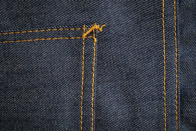 Ciemnoniebieskie dżinsy tekstura tło z kieszenią.