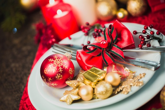 Ciepłe świąteczne lub świąteczne nakrycie stołu ze sztućcami i serwetką
