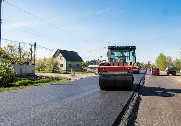 Ciężki walec wibracyjny na nawierzchni asfaltowej pracujący na budowie nowej drogi Naprawa