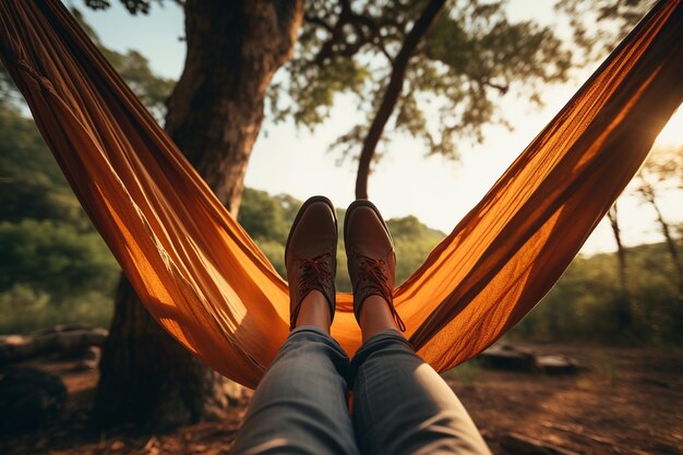 Zdjęcie close up shot of a persons feet lounging in a hammock between trees