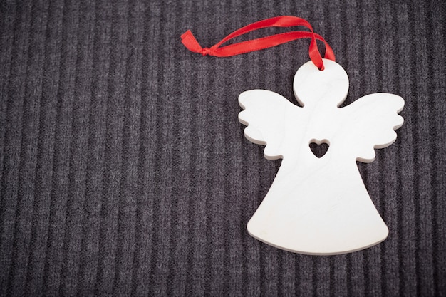 Zdjęcie craft wooden angel on grey knitted