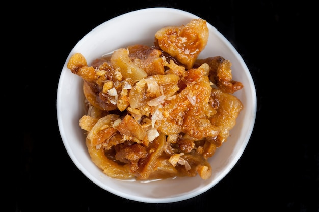 Crispy Pork With Fried Garlic In White Bowl On Black Background.