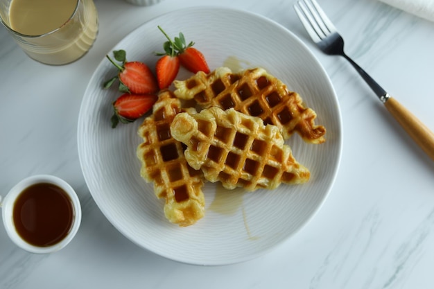 Croissant Wafel lub Croffle w białym talerzu z truskawkami