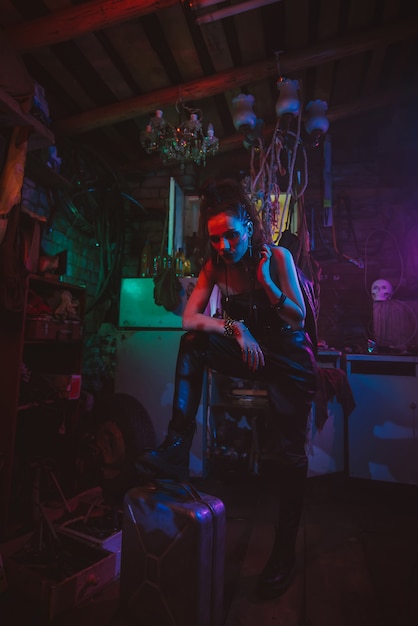 Cyberpunkowa Dziewczyna W Postapokaliptycznym Futurystycznym Stylu W Garażu Z Neonowym światłem. Steampunkowy Cosplay