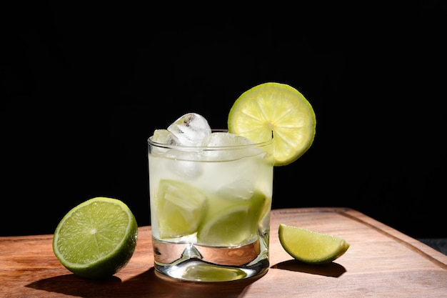 cytryna i cachaa caipirinha typowy brazylijski napój szklanka z caipirinha na czarnym tle