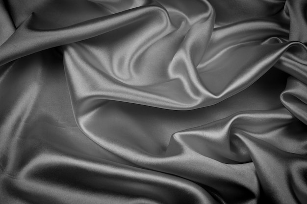 Czarna jedwabnicza tekstura luksusowy atłas dla abstrakcjonistycznego tła. Ciemny odcień tkaniny