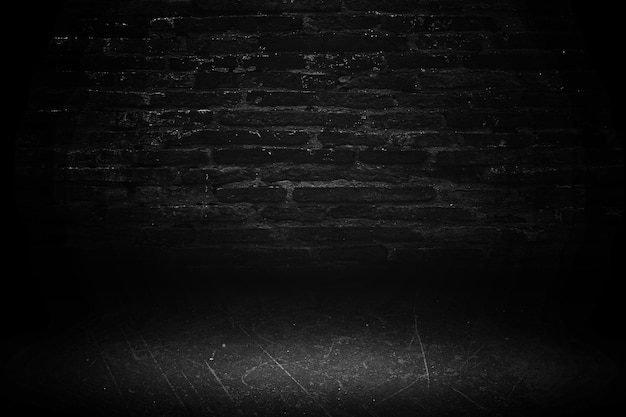 Czarne tło w pokoju studyjnym tekstura wnętrza dla wyświetlaczy ściana z cegły i czarna podłoga z cementu