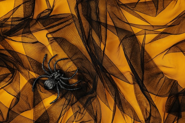 Czarno-pomarańczowe abstrakcyjne tło z pająkiem, koncepcja na Halloween
