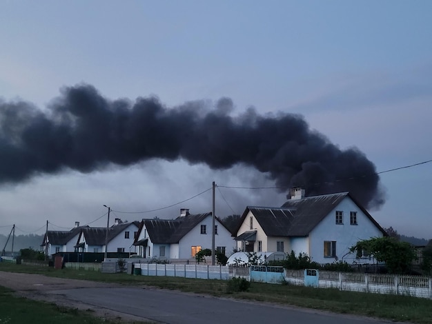 Zdjęcie czarny, gęsty dym nad domem. dom się pali