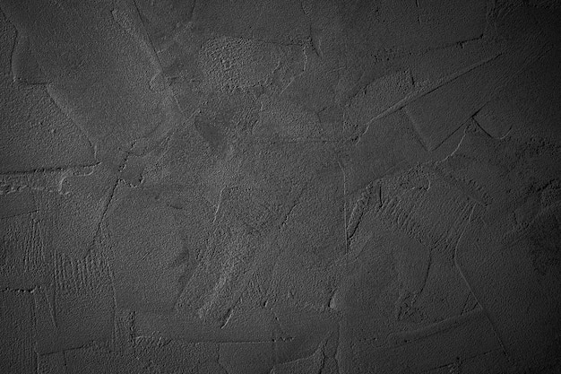 Zdjęcie czarny lub ciemnoszary szorstki ziarnisty kamienny mur tekstura tło