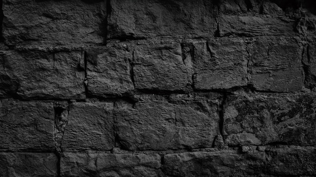 Czarny stary mur z cegły. Ciemna cegła tekstura. Ponure tło grunge