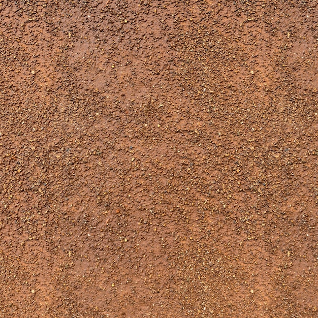 czerwone błoto tekstury tła, widok z góry czerwonego błota brudu z małymi skałami na powierzchni