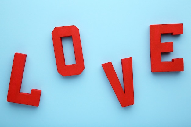 Czerwone litery kochają na niebiesko, słowo miłość.