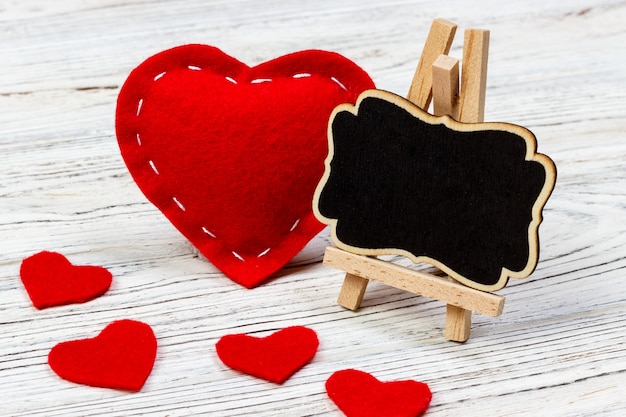 Zdjęcie czerwone serce z czarną deską i małymi sercami.