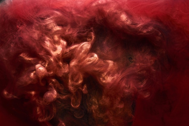 Czerwony czarny musujący abstrakcyjne tło luksusowy złoty dym farba akrylowa podwodny wybuch kosmiczny wirujący atrament