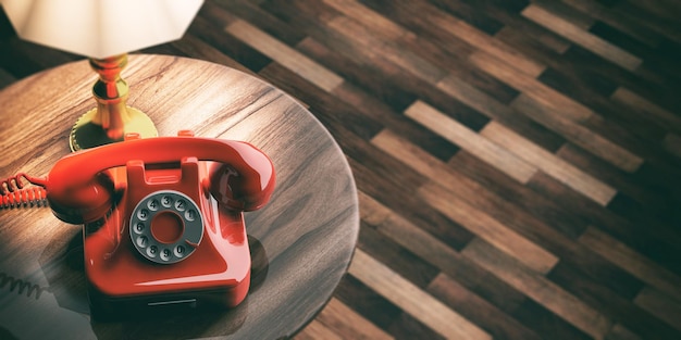 Zdjęcie czerwony stary telefon na drewnianej tła 3d ilustraci