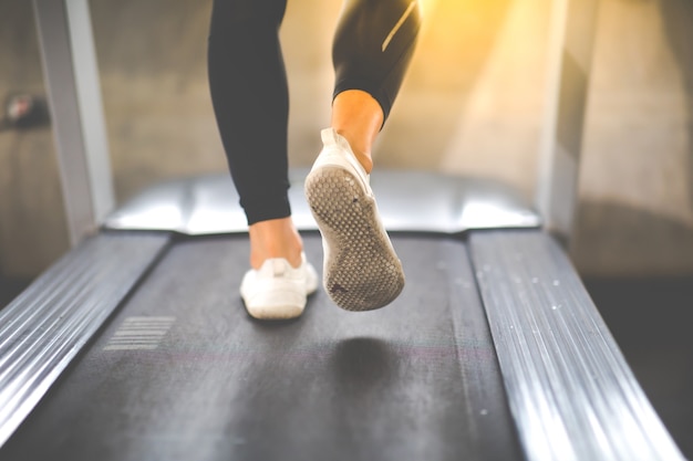 Człowiek Działa Na Maszynie Bieżni W Klubie Sportowym Siłowni. Zdrowy Styl życia Fitness I Trening W Koncepcji Siłowni. Selektywne Skupienie Na Butach Do Walki Wręcz.