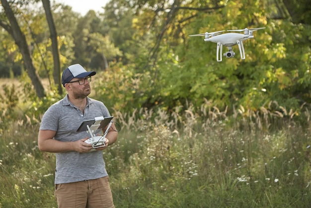 Człowiek zarządza quadrocopterami Zdalne sterowanie dronem w rękach mężczyzn Bezzałogowy statek powietrzny