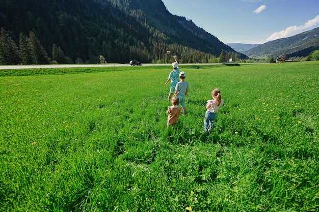 Czworo dzieci bawi się na alpejskiej łące w Untertauern Austria