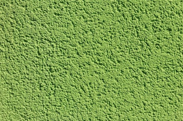 Dekoracyjna zielona tekstura tynku na ścianie Tekstura zielonej ściany stiukowej na tle