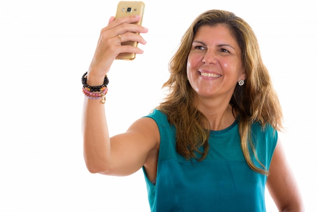 Zdjęcie dojrzała szczęśliwa kobieta uśmiecha się podczas robienia zdjęcia selfie