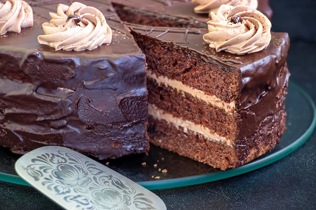 Zdjęcie domowe warstwowe ciasto czekoladowe z kremowym białym talerzem selektywne skupienie zbliżenie