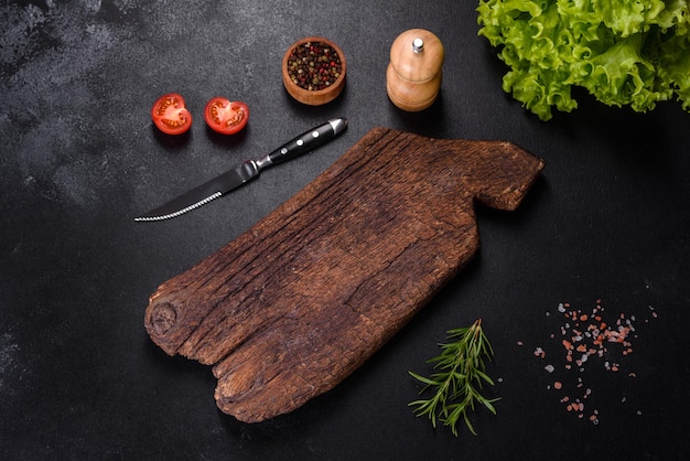 Drewniana deska do krojenia z nożem kuchennym z przyprawami i ziołami