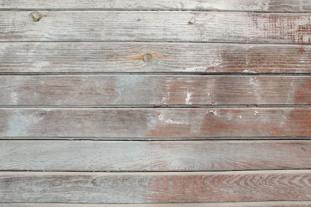 Drewniana stara odrapana kolorowa ściana na pełnym ekranie Sfotografowana z bliskiej odległości