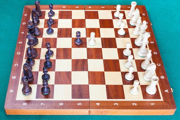 Drewniana szachownica z pierwszymi ruchami pionków szachowych