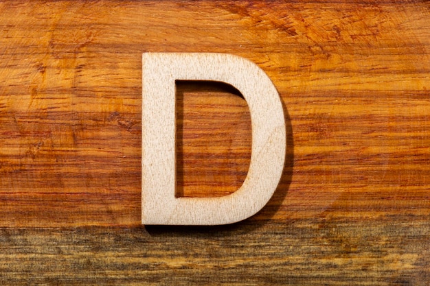 Zdjęcie drewniane litery d na drewnianym tle