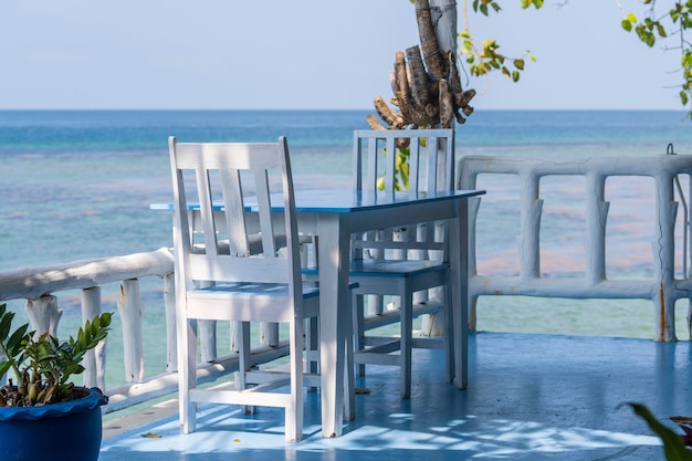 Drewniany stół i krzesła w tropikalnej kawiarni na plaży w pobliżu wyspy wody morskiej Koh Phangan Tajlandia