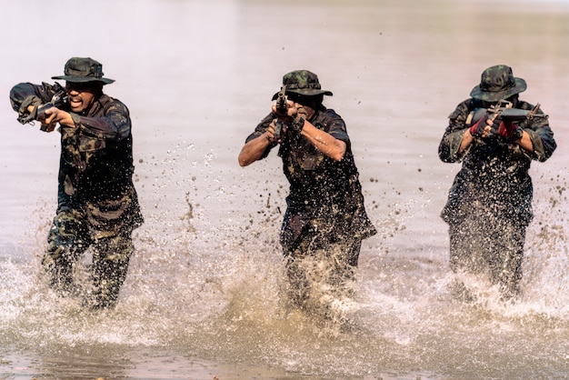Drużyna żołnierzy biegnących w wodzie