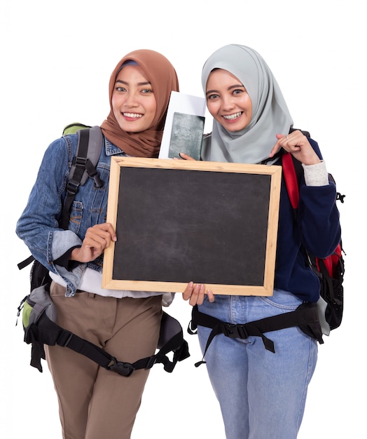 Dwa muzułmańskich kobiet backpacker z tablicą