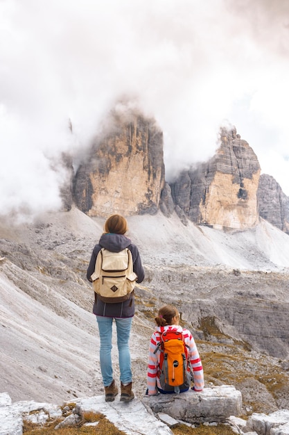 Dwie dziewczyny turystów odpoczynku i patrząc na skały. Tre Cime di Lavaredo, góry Dolomity, Włochy