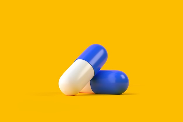 Dwie niebiesko-białe kapsułki tabletek na żółtym tle leczenie medyczne renderowanie farmaceutyczne 3D