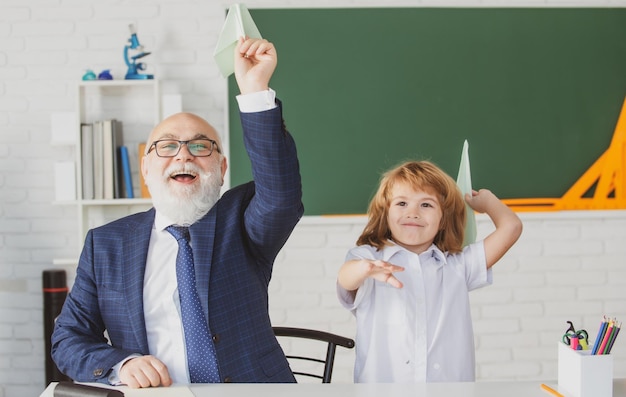 Dziadek Pomaga Wnukowi Przy Zadaniach Szkolnych Rozwijanie Troskliwych Uczniów, Którzy Aktywnie Się Rozwijają I Osiągają Sukcesy Staruszek Pedagog I Uczeń Dobrze Się Bawią