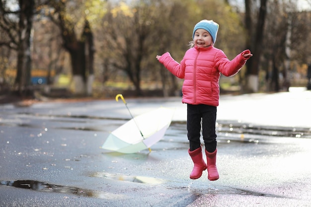 Dzieci spacerują po jesiennym parku jesienią