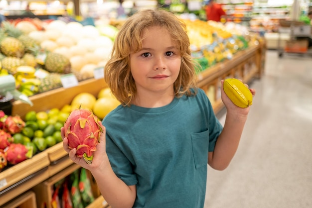 Dzieciak z owocami Dziecko wybiera jedzenie w sklepie spożywczym lub w supermarkecie owoców i warzyw