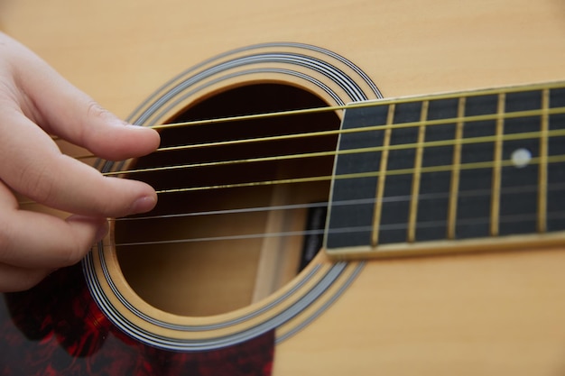 Dziecko uczy się grać na skali instrumentu muzycznego na gitarze