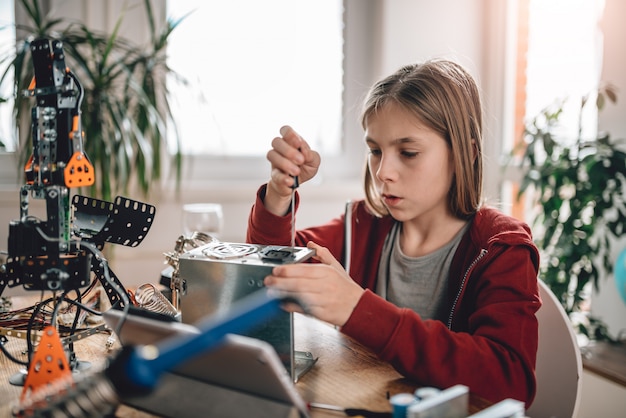 Dziewczyna modyfikująca zasilanie i uczącą się robotyki