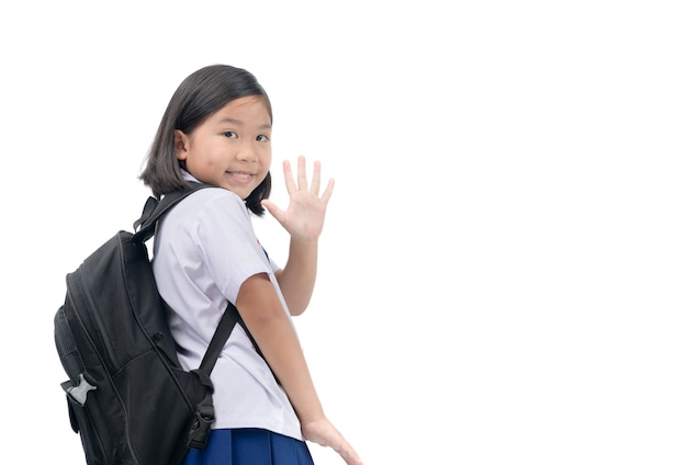 dziewczyna uczeń idzie do szkoły i macha na pożegnanie