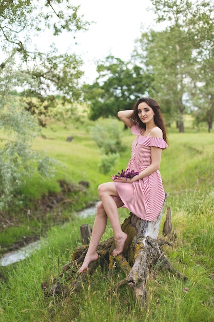 Dziewczyna w czerwonej sukience na łonie natury w lecie Portret pięknej dziewczyny latem w lesie