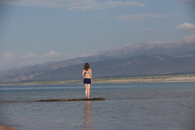 Dziewczyna w stroju kąpielowym na górskim jeziorze