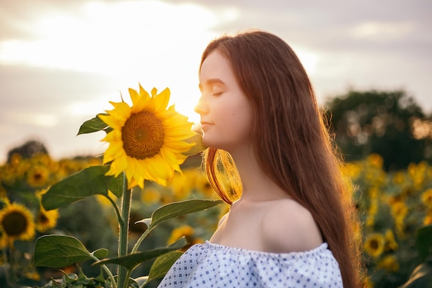 Dziewczyna z żółtym bukietem kwitnącego pola słonecznika